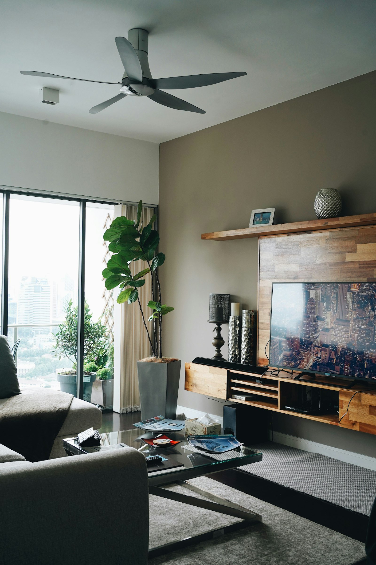 Barra de sonido negra apoyada en mueble de madera bajo el televisor